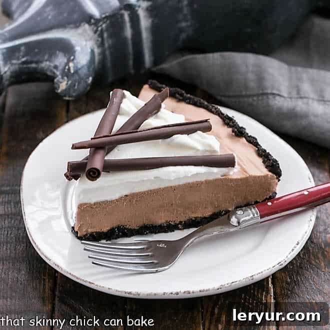 Slice of Candy Bar Pie on a small white plate wit a red handle fork