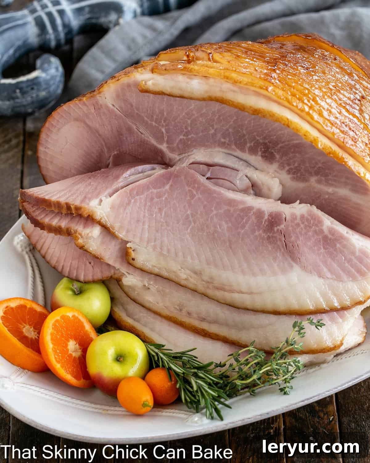 A close-up shot of the glistening honey mustard glazed ham, showcasing its golden-brown crust and juicy texture, ready to be carved and served for a festive meal.