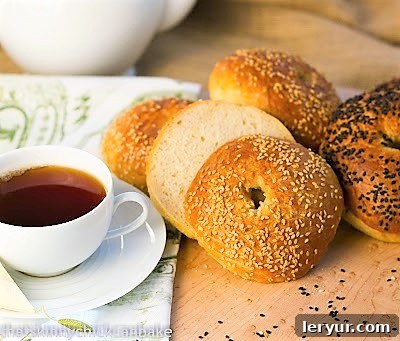 A tray of homemade bagels from 2012, served with a comforting cup of tea, showcasing the timeless appeal of home baking.