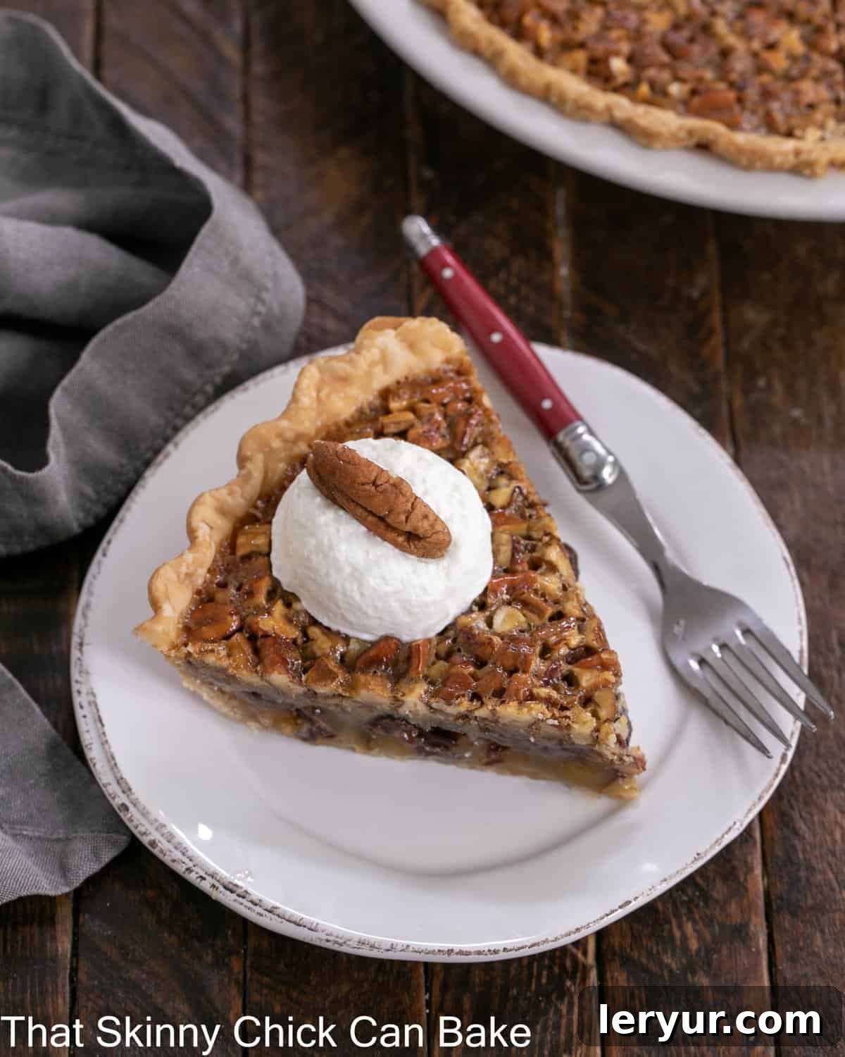 Decadent Chocolate Pecan Indulgence 2 Overhead view of a slice of derby pie topped with whipped cream and a pecan on a white dessert plate