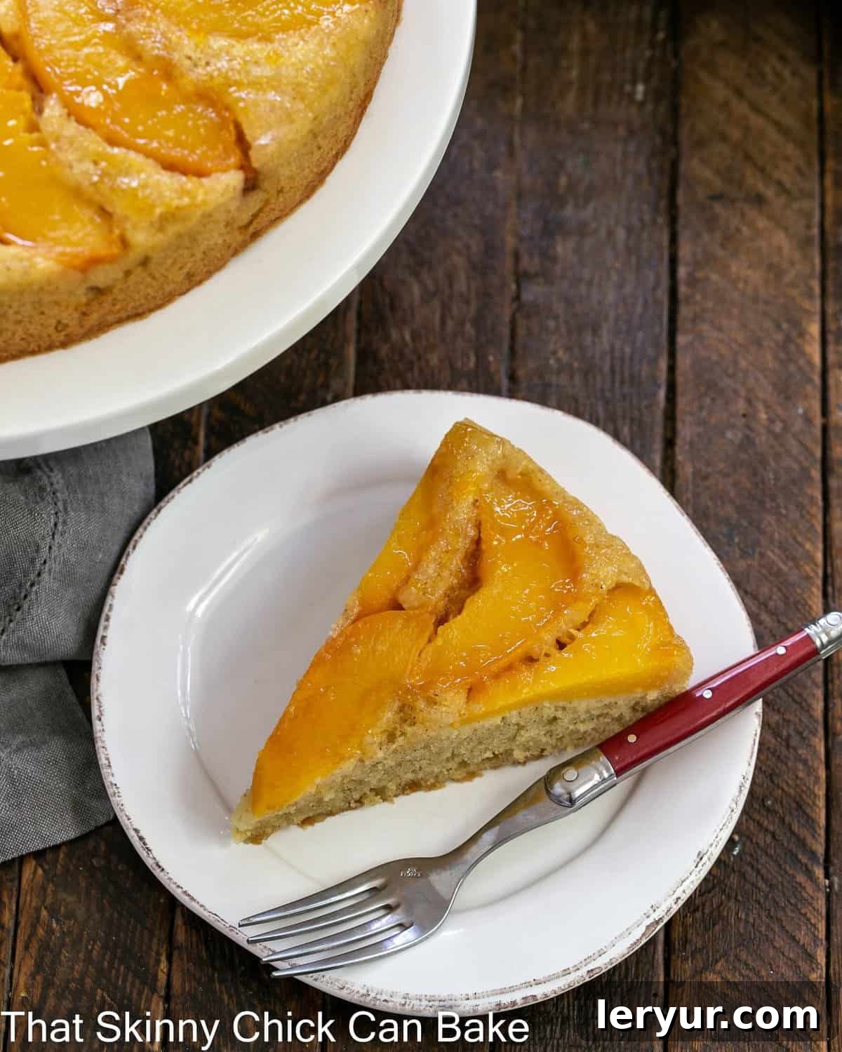 Caramelized Peach Flip Cake 4 A slice of upside down cake with peaches on a white plate viewed from above, showcasing the juicy, golden peaches.