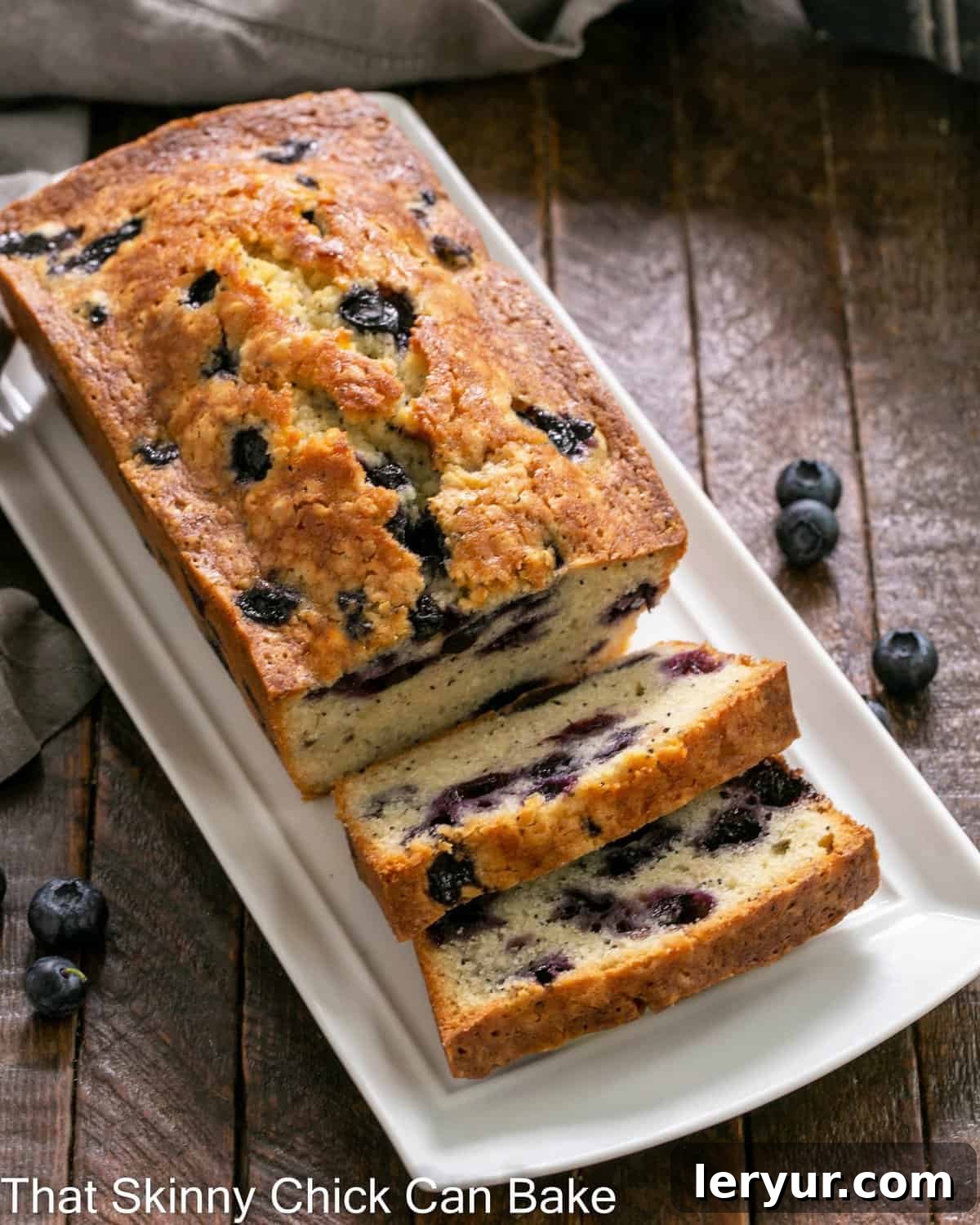 Morning Blueberry Poppy Seed Bake 2 Overhead view of perfectly sliced blueberry poppy seed bread, showcasing juicy blueberries and poppy seeds.