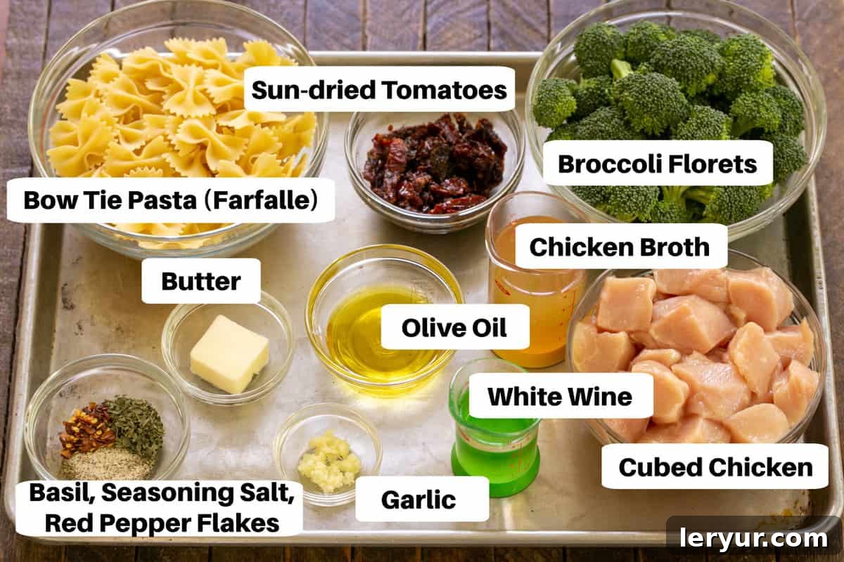Vibrant Sun-Dried Tomato Chicken Broccoli Pasta 2 Chicken with Broccoli Ingredients neatly arranged on a metal sheet pan with labels.