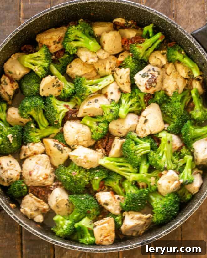 Vibrant Sun-Dried Tomato Chicken Broccoli Pasta 4 Chicken in skillet with broccoli.