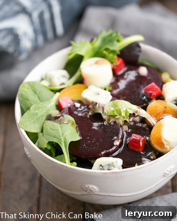 A beautifully presented Beet Salad with Blue Cheese and Hearts of Palm in a pristine white salad bowl, showcasing vibrant colors and fresh ingredients.