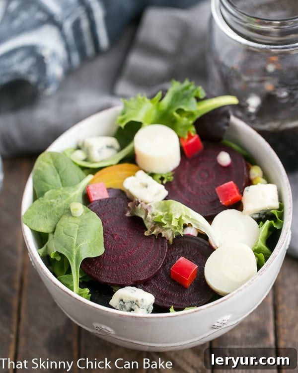 A close-up view of Beet Salad with Blue Cheese and Hearts of Palm presented in a elegant white ceramic bowl, ready to be served.