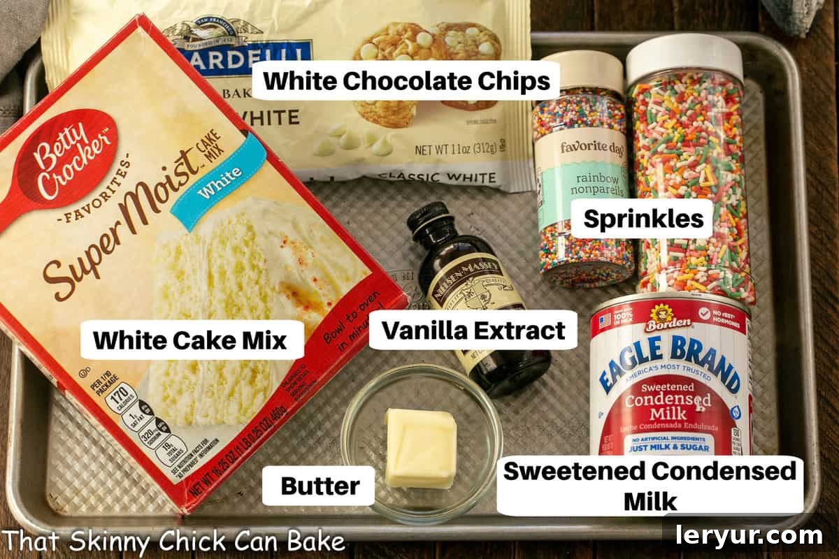 Confetti White Chocolate Fudge 3 White Chocolate Cake Batter Fudge Ingredients with labels neatly arranged on a metal sheet pan.