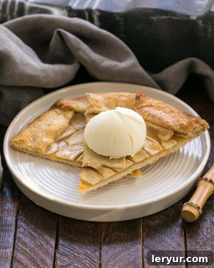 Two slices of Apple Tart on a white plate with a scoop of ice cream