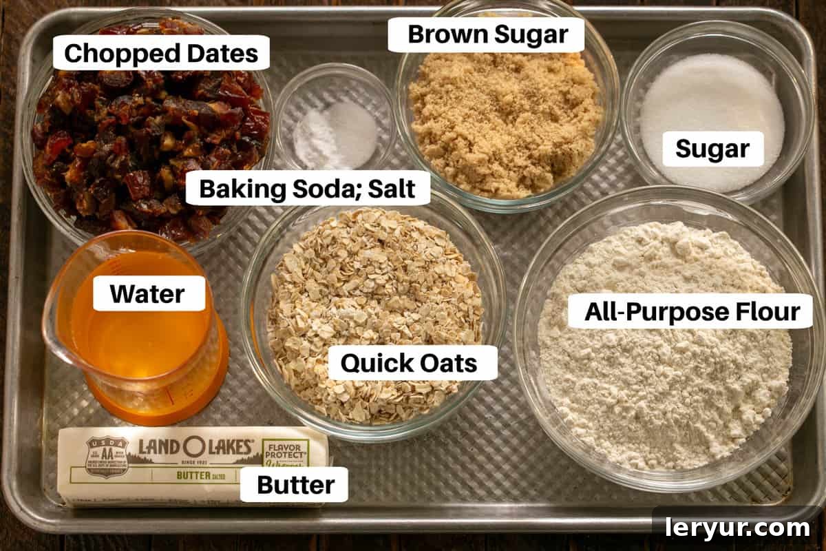 A collection of fresh ingredients for date streusel bars, including Medjool dates, oats, flour, sugar, and butter, neatly laid out on a baking sheet with descriptive labels.