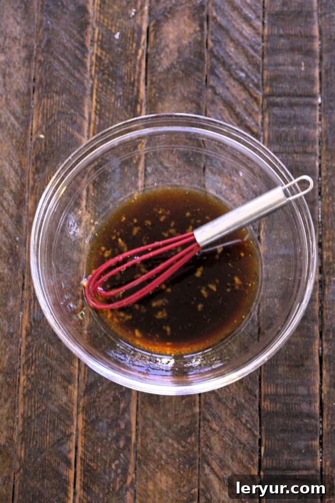 Grilled Salmon Date Night 4 All salmon marinade ingredients being whisked together in a glass bowl.