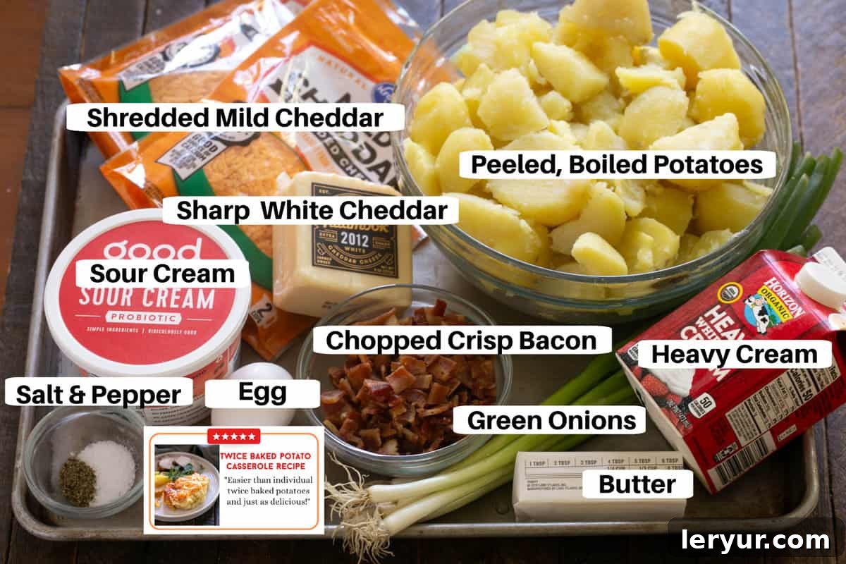All the fresh ingredients for Twice Baked Potato Casserole meticulously laid out on a metal sheet pan, including potatoes, bacon, various cheeses, sour cream, and green onions.