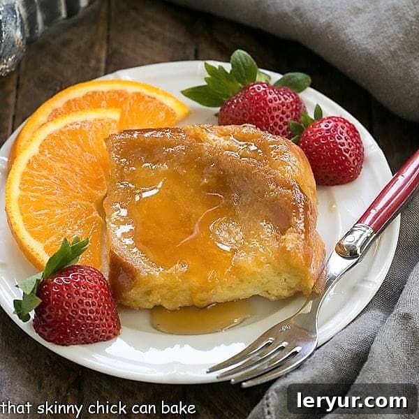 Creme Brulee French Toast - an exquisite, make ahead breakfast casserole! A perfectly caramelized slice of Crème Brûlée French Toast, topped with syrup, resting on a small white plate, ready to be enjoyed.