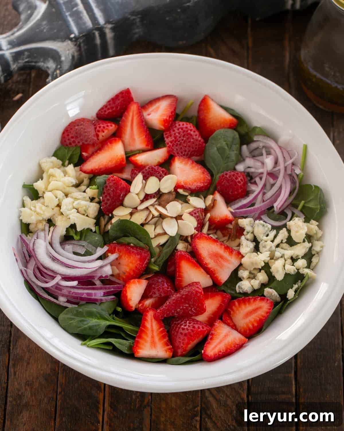 Vibrant Strawberry Spinach Salad with Tangy Blue Cheese 5 Overhead view of salad in a serving bowl.