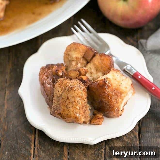 Crock Pot Apple Monkey Bread: a sweet, pull-apart breakfast or dessert made easy in the slow cooker with canned biscuits and apples.