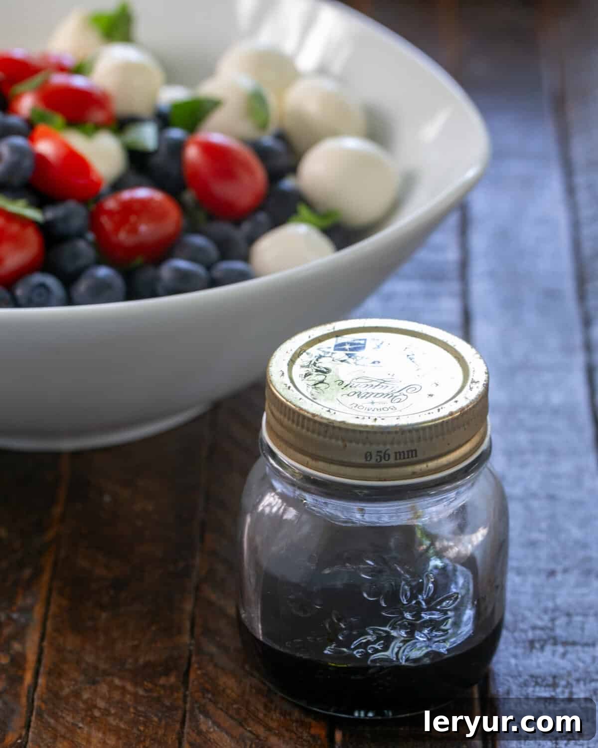 Berry-Kissed Caprese Salad 2 Blueberry Caprese Salad in a white bowl with Balsamic vinegar.
