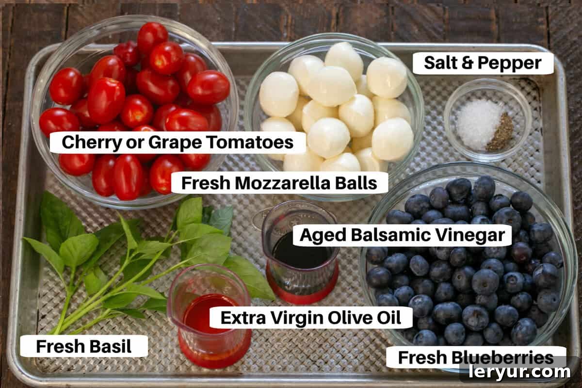 Berry-Kissed Caprese Salad 3 Blueberry Caprese Salad Ingredients on a metal sheet pan with labels.