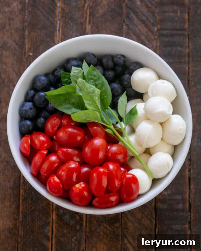 Berry-Kissed Caprese Salad 4 Caprese salad with blueberries ingredients.