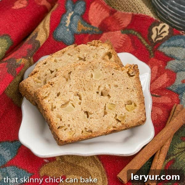 A full loaf of Apple Cinnamon Bread, perfectly golden brown and ready to be sliced, inviting you to taste its warmth and sweetness.