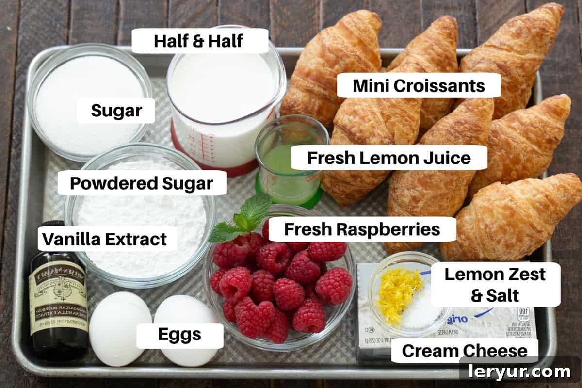 Decadent Croissant French Toast with Juicy Raspberries 3 French toast casserole ingredients with clear labels on a metal sheet pan, ready for assembly.