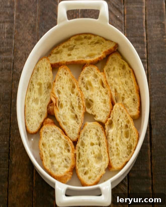 Decadent Croissant French Toast with Juicy Raspberries 5 Step 2: Mini croissants cut in half and arranged cut-side up in a baking dish.