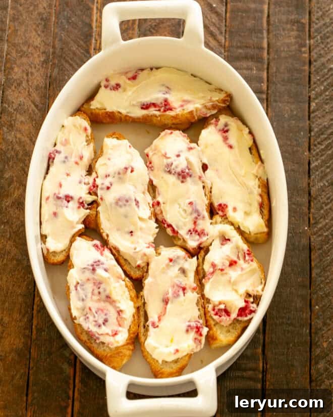 Decadent Croissant French Toast with Juicy Raspberries 6 Step 3: Spreading the cream cheese mixture evenly over the croissant bottoms.