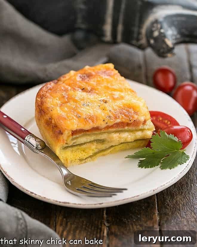 A delectable slice of Low Carb Chili Relleno Casserole presented on a round white plate, ready to be enjoyed with a red-handled fork.