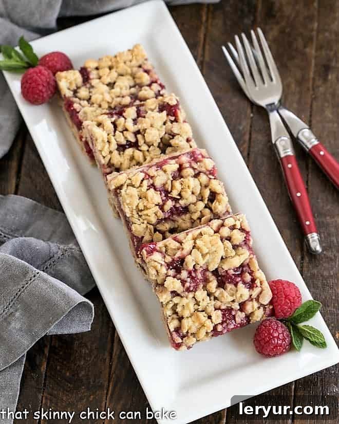 Overhead view of raspberry oatmeal bars on a white serving tray