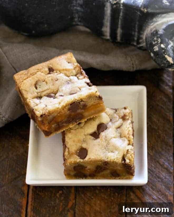 Decadent Caramel Chocolate Chip Bars 13 2 chocolate caramel bars on a square white plate.