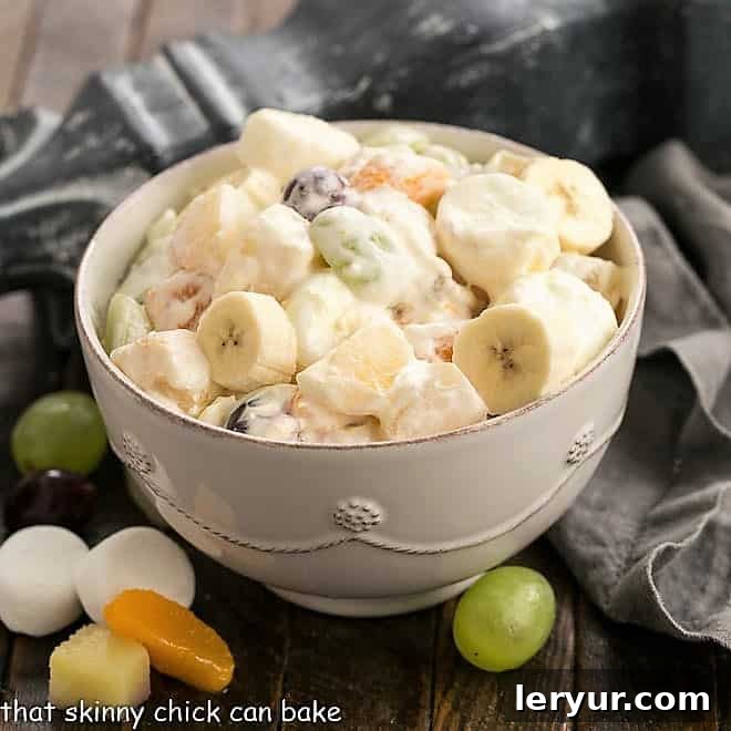 Holiday fruit salad featured image, showcasing a delightful mix of fruits and marshmallows in a creamy dressing.