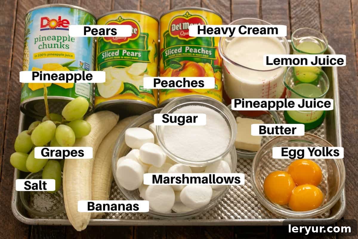 Holiday Ambrosia Salad 2 A vibrant selection of ingredients for overnight fruit salad, neatly labeled and arranged on a metal sheet pan, showcasing the fresh and canned components.