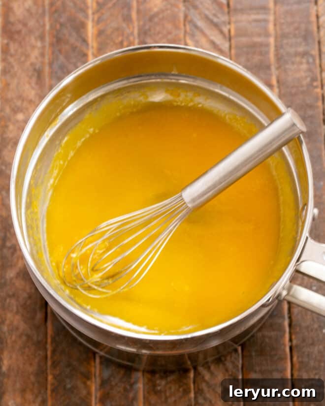 Holiday Ambrosia Salad 3 Making the lemon custard in a double boiler, ensuring gentle heating and a smooth texture.