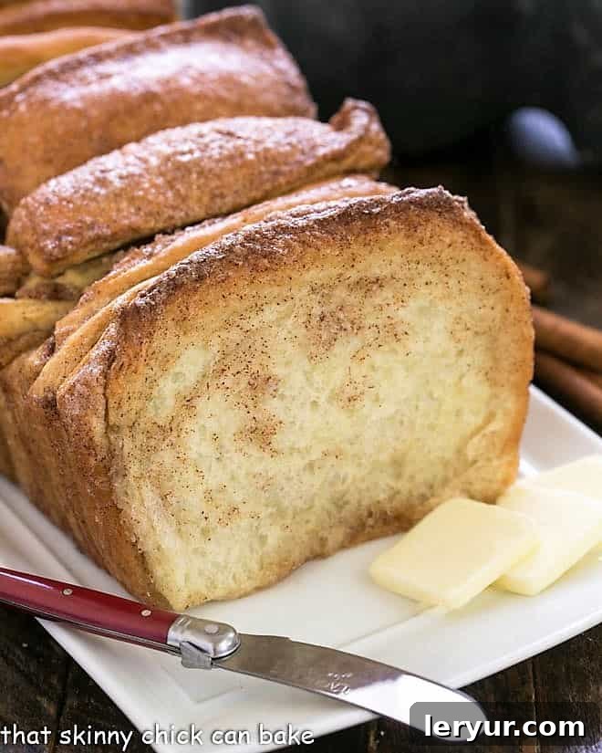 Sticky Cinnamon Tear & Share Bread 2 Cinnamon Pull Apart Bread on a white tray with a knife and butter pats