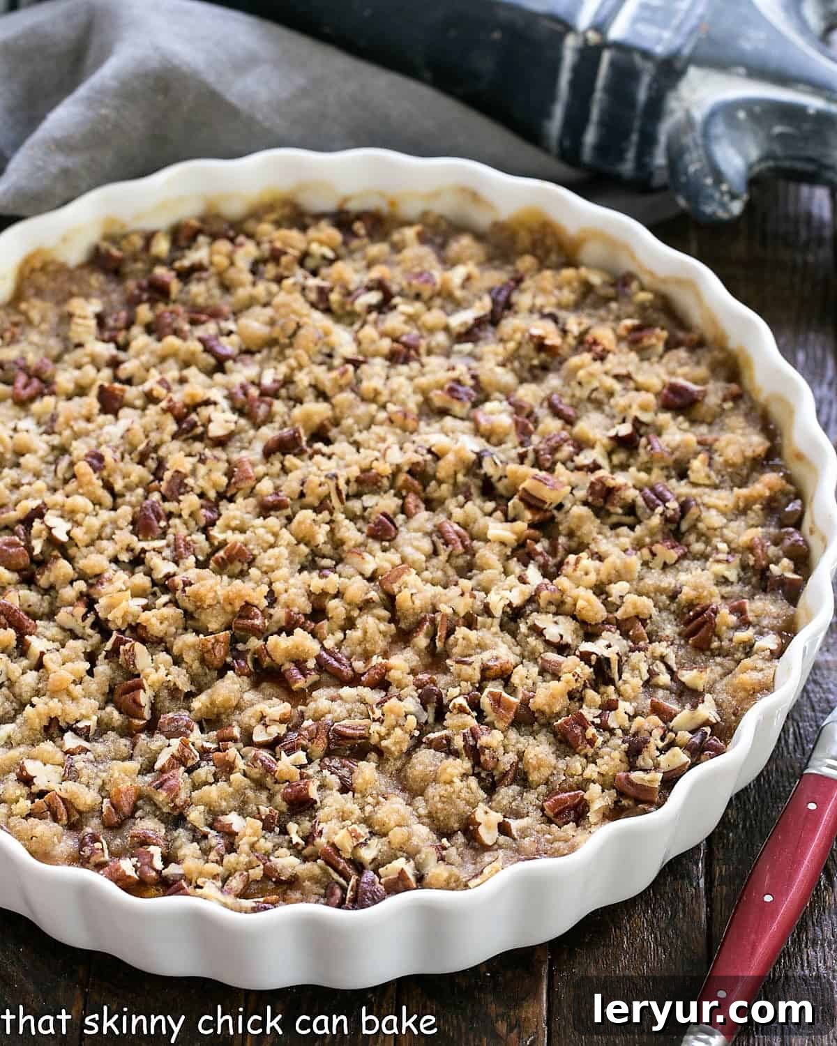Overhead view of Praline Topped Sweet Potato Casserole in a white, round casserole dish, perfectly golden.