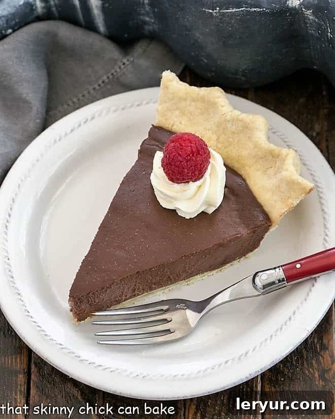 Slice of pdding pie on a white dessert plate.