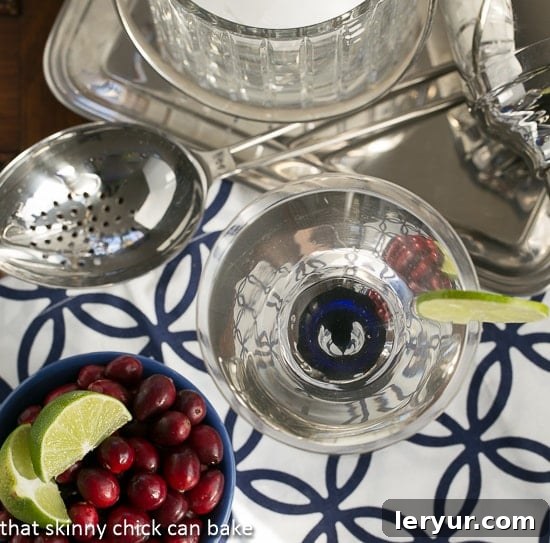 White Cosmopolitans from above with a bowl of garnishes.