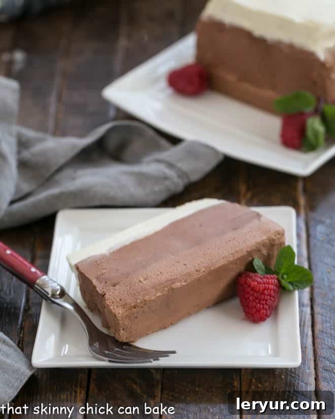 Triple Chocolate Mousse Recipe - a no-bake layered chocolate dessert made in a loaf pan! Slice of triple chocolate mousse on a white plate with a red handle fork.