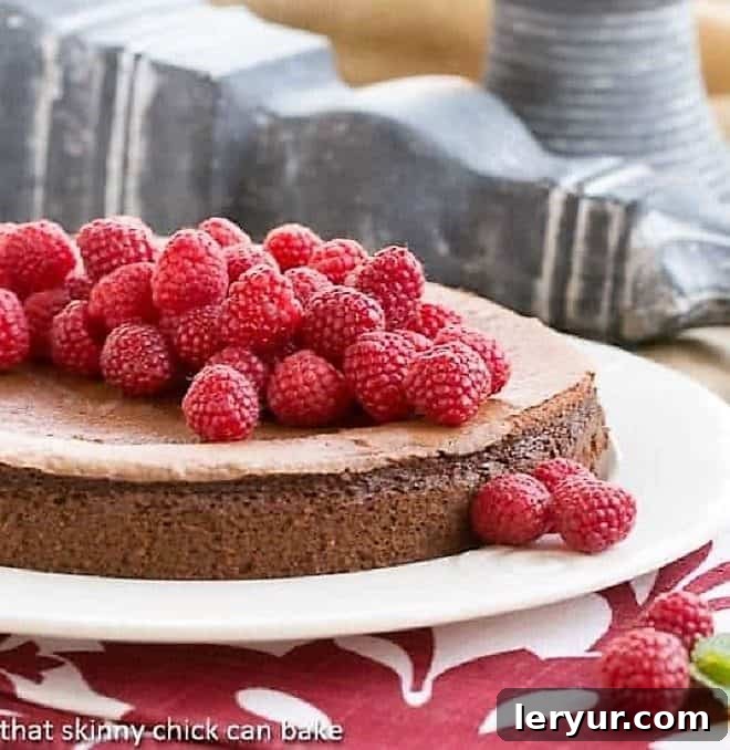 Chocolate Mousse Torte covered with fresh raspberries, showcasing its rich texture