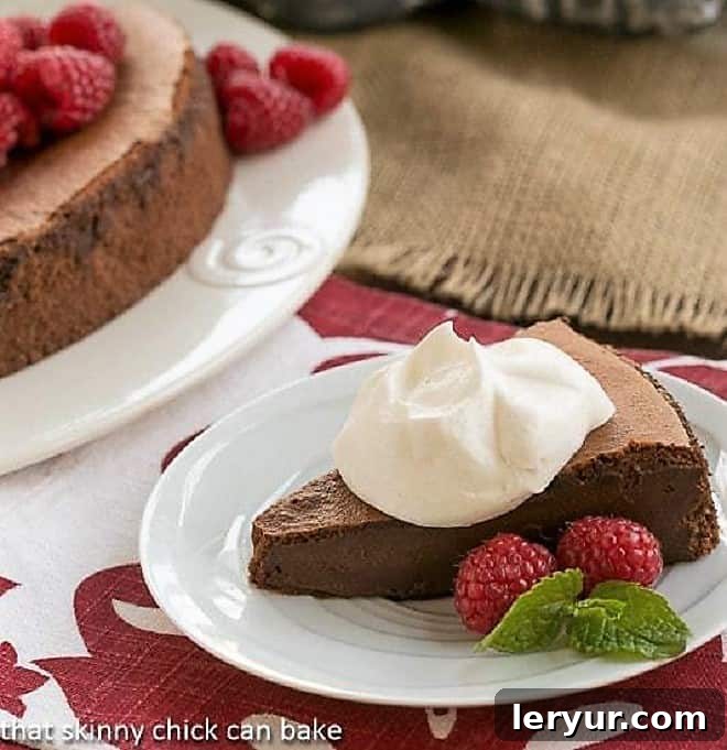 Chocolate Mousse Torte topped with whipped cream, garnished with chocolate shavings