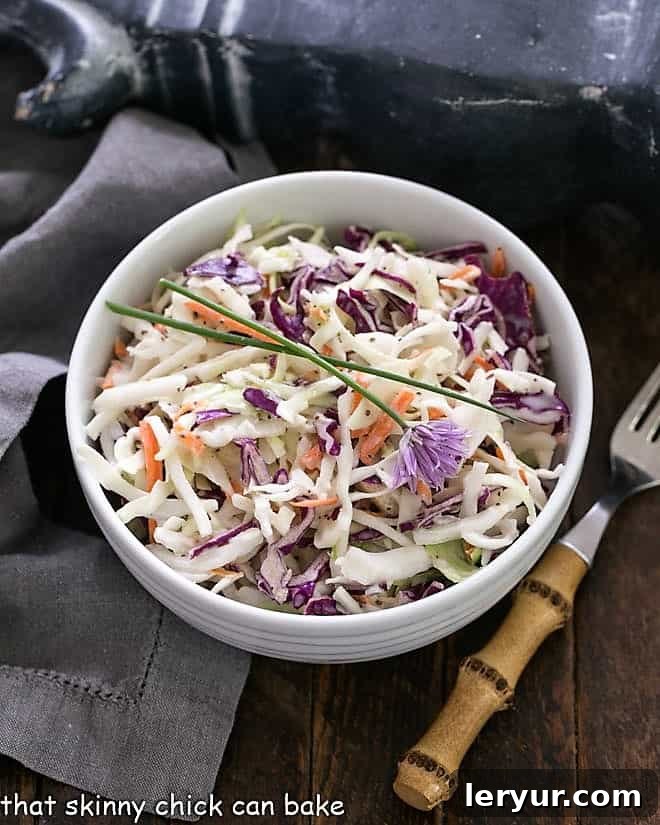 KFC-style Coleslaw with Buttermilk Dressing in a white serving bowl, perfect for picnics and gatherings.