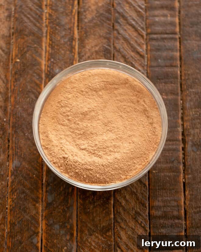 Dry ingredients for the fudge cake, including flour and cocoa powder, in a mixing bowl ready to be whisked.