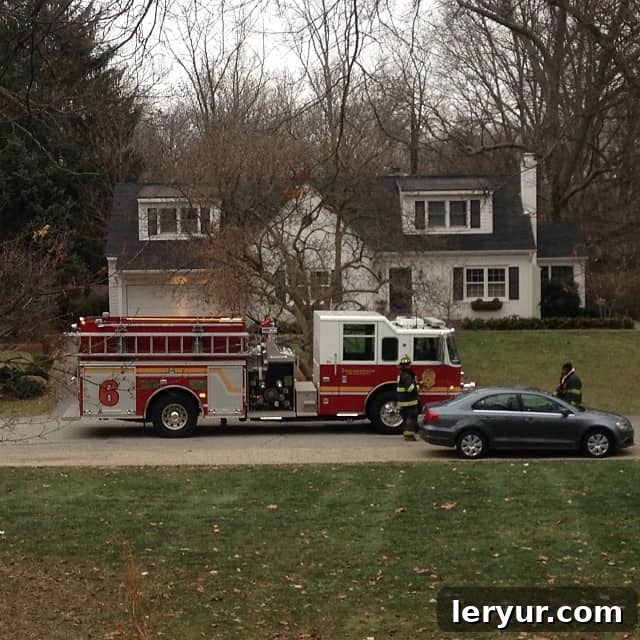 A firetruck parked in front of a house, symbolizing a past kitchen incident.