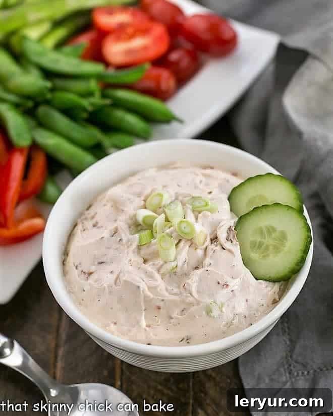 Ina's Sun-dried Tomato Dip - an easy, irresistible dip made your food processor! Perfect for any party. Vibrant Sun-dried tomato dip presented in a white bowl, ready to be served.