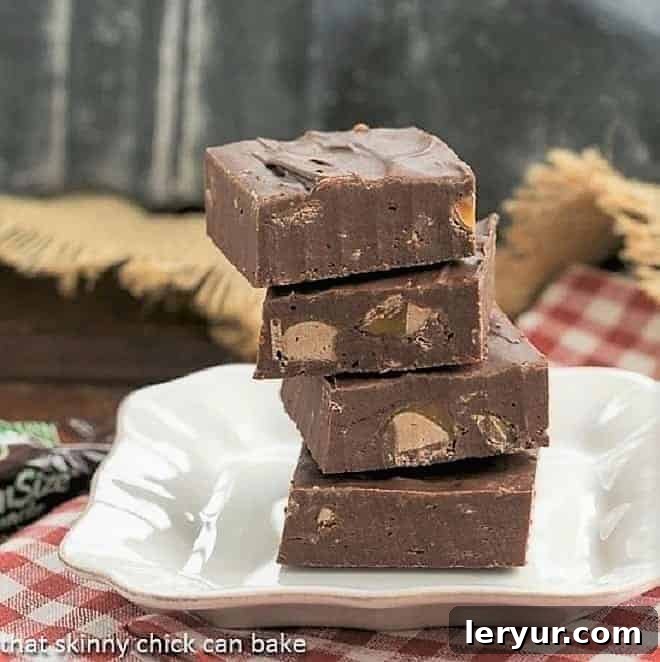Milky Way Fudge squares stacked on a white dessert plate