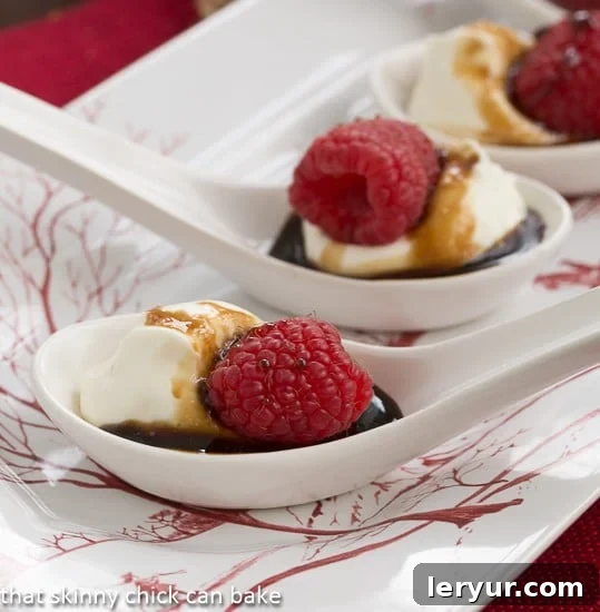 Closeup view of exquisite Balsamic Raspberries with Mascarpone Cream served in pristine white Chinese soup spoons