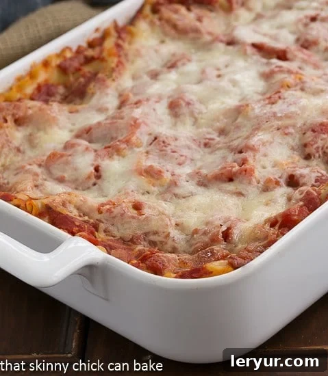A large baking dish filled with Easy Sausage and Mushroom Lasagna, fresh out of the oven, its golden-brown, bubbly cheese topping and rich, aromatic layers promise a comforting meal.