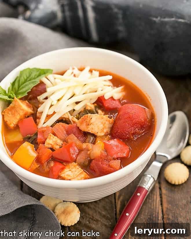 A generously filled white bowl of Chicken and Bell Pepper Chili, ready to be served and enjoyed.