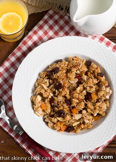 Chunky Maple Coconut Granola viewed from above, elegantly arranged in a white bowl with a charming red and white checked napkin underneath.