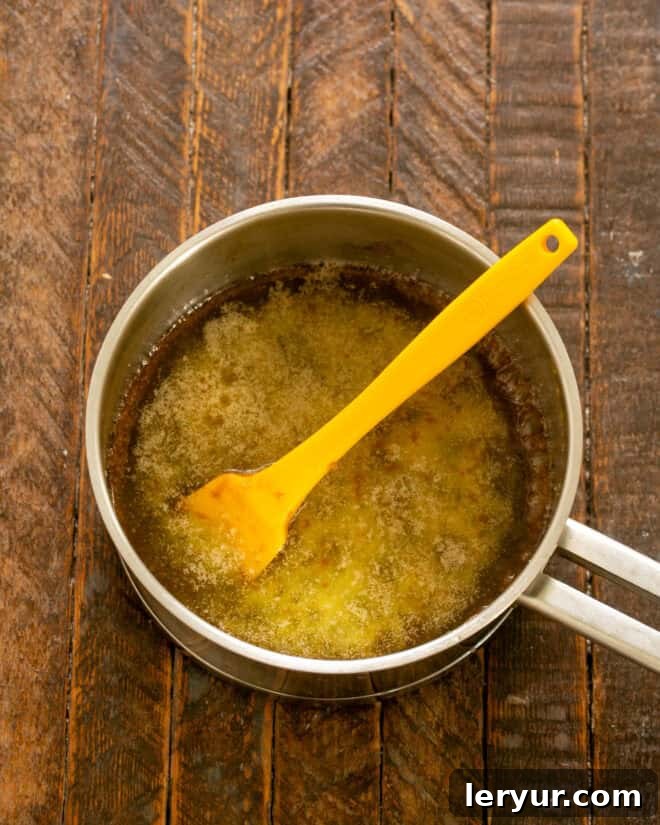 Step 2: Boil butter and brown sugar together in a saucepan for 3 minutes until smooth.