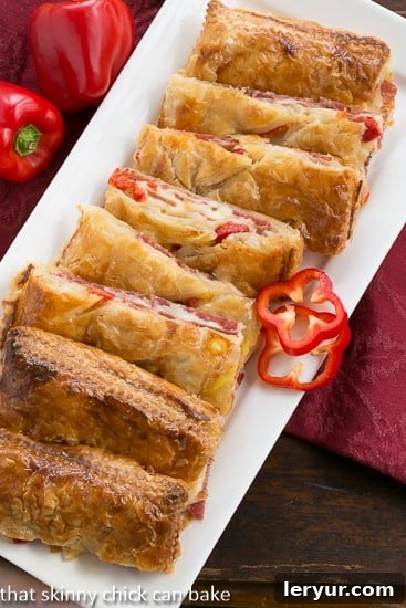 Close-up of golden brown Puff Pastry Antipasto Squares, showing layers of meat and cheese