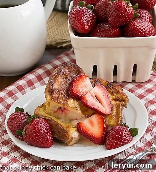 Stuffed French Toast Recipe - An elegant brunch entree filled with rich mascarpone cheese and fresh strawberries. Strawberry Mascarpone Stuffed French Toast cut in half and served topped with sliced strawberries and powdered sugar.